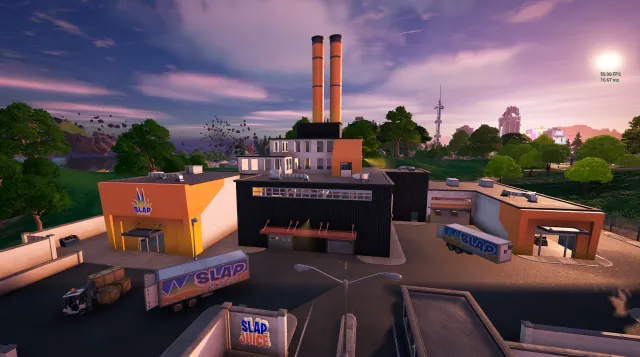 Slap Factory, un edificio predominantemente negro con pintura naranja y blanca, y dos chimeneas naranjas que salen de lo alto. 
