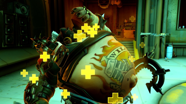Roadhog usa su habilidad Take a Breather mientras los signos flotantes amarillos más lo rodean.